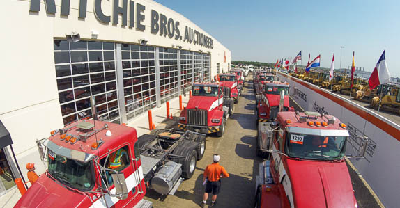 Hitachi and Komatsu hydraulic excavators at the auction site.