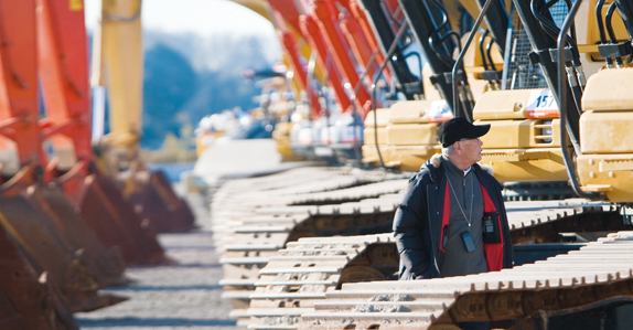 A prospective buyer inspecting an excavator
